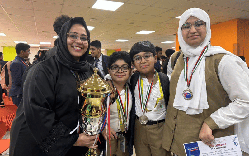 Students holding trophy and medals after winning second place at AI4UNITY 2025