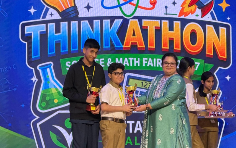 Zahi Najmal and teammate Sainto Sibi receiving first place trophy at Thinkathon Science and Math Fair for Muttasil smart mosque system project